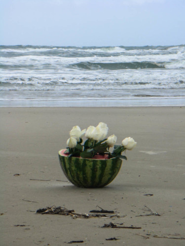 Beauty in the form of a bouquet in a watermelon on the beach.
